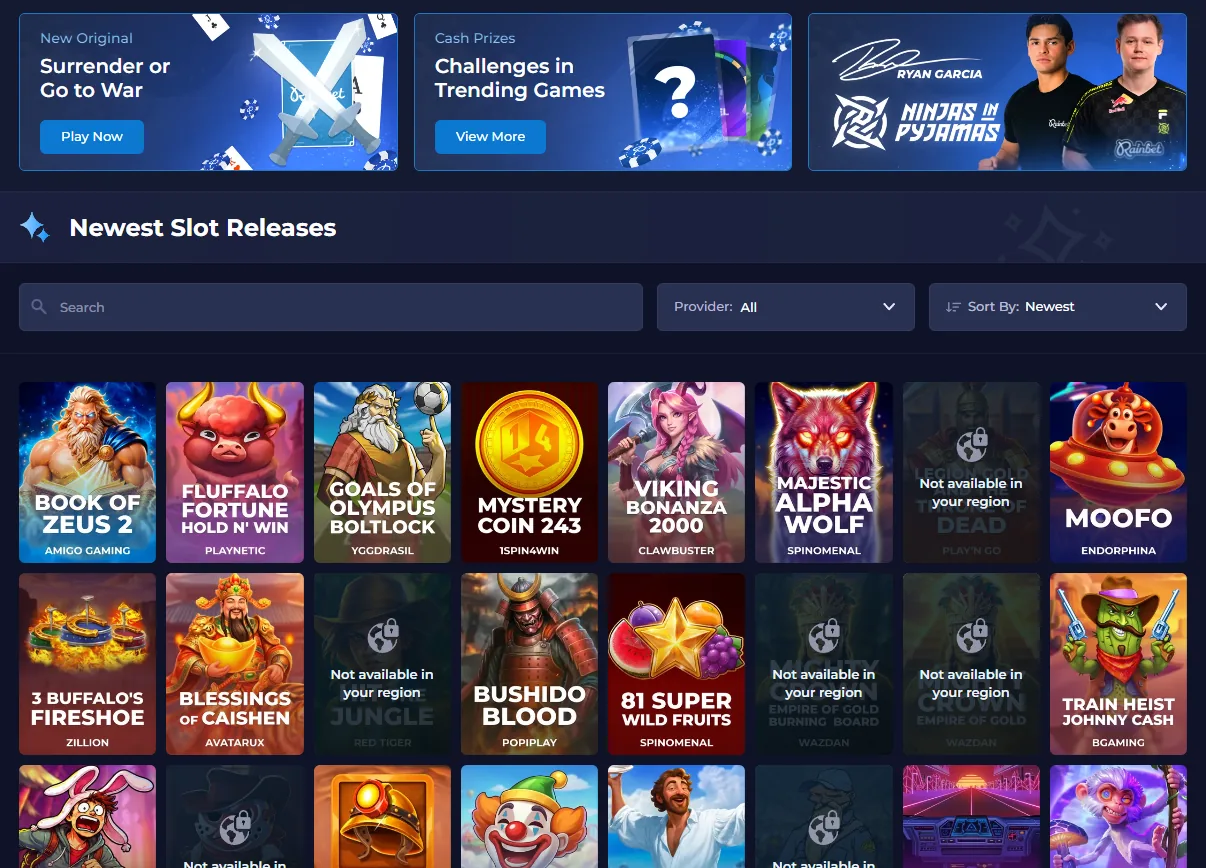 Rainbet lobby showing promotional banners for the Surrender or Go to War original and trending-game challenges above a Newest Slot Releases grid with titles from Amigo Gaming, Playnetic, Clawbuster and other studios